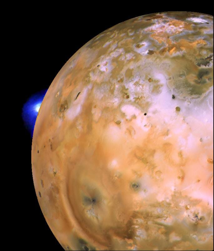 Voyager 1 mosaic of Io from March 1979 showing a bright volcanic plume rising from the moon's limb, with a heart-shaped ring of fallout deposits from another plume to the southeast.