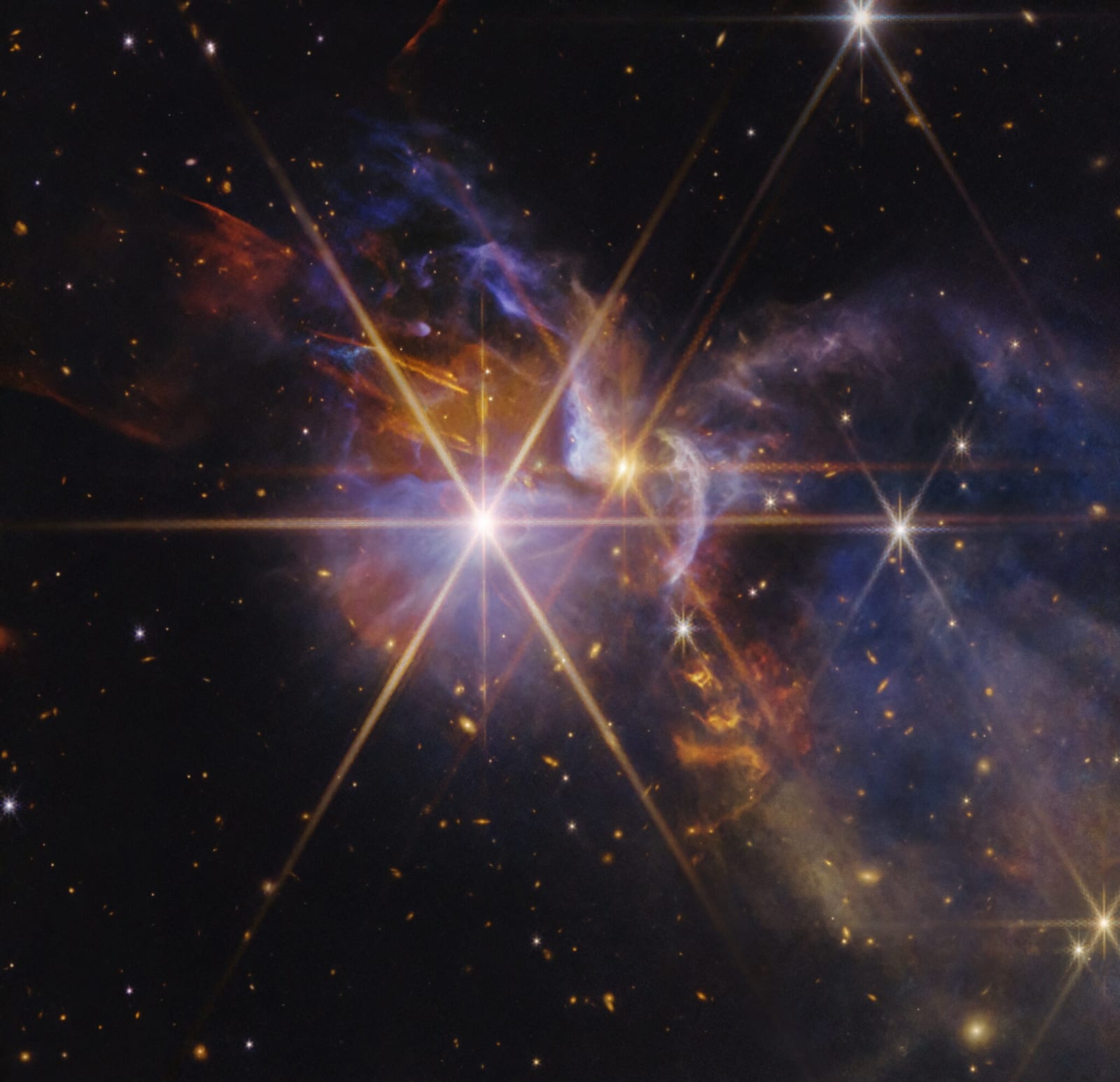 JWST NIRCam image of the highly distorted red galaxy MRG-M0138 seen through a foreground cluster of galaxies. The same background galaxy is multiply imaged four times via gravitational lensing. Credit: NASA / ESA / CSA / Webb.